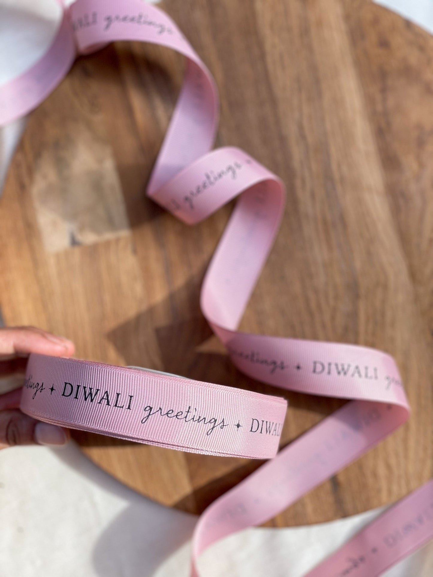 Pre-designed festive ribbon with printed designs for gift wrapping and decorations.- Lemonade Stationery  
Diwali Greetings - Pink LemonadeStationery