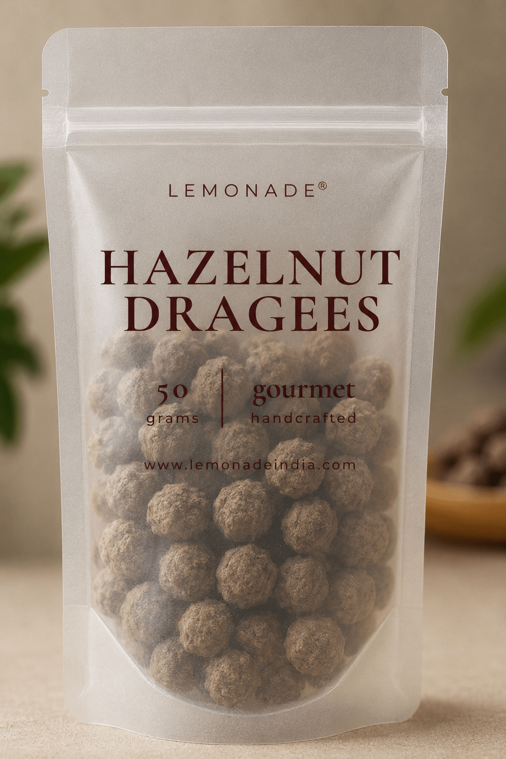 Gourmet hazelnut dragées in premium packaging, featuring whole roasted hazelnuts coated in smooth milk chocolate