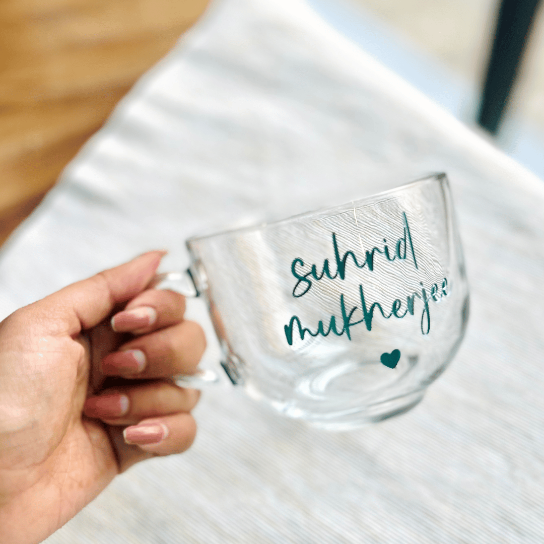 A clear glass mug with text colour Tiffany blue  suggesting a personalized touch.