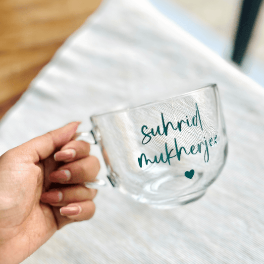 A clear glass mug with text colour Tiffany blue  suggesting a personalized touch.