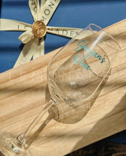 Close up of handcrafted calligraphy engraving on artisan wine glasses