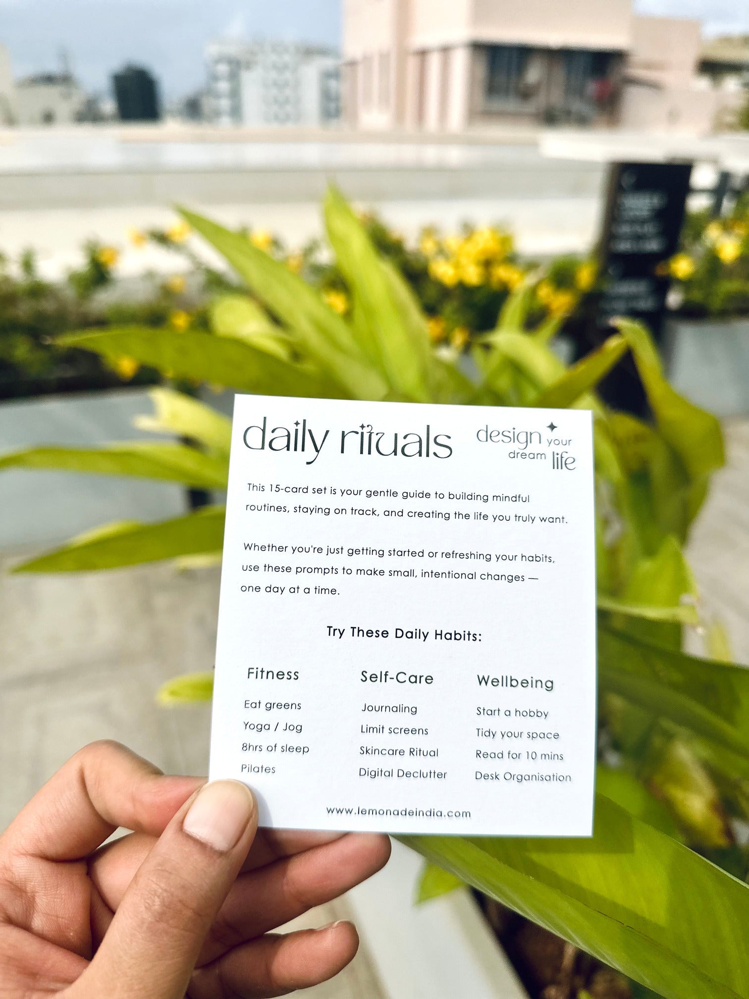 hand holding weekly habit tracker notepad with routine list