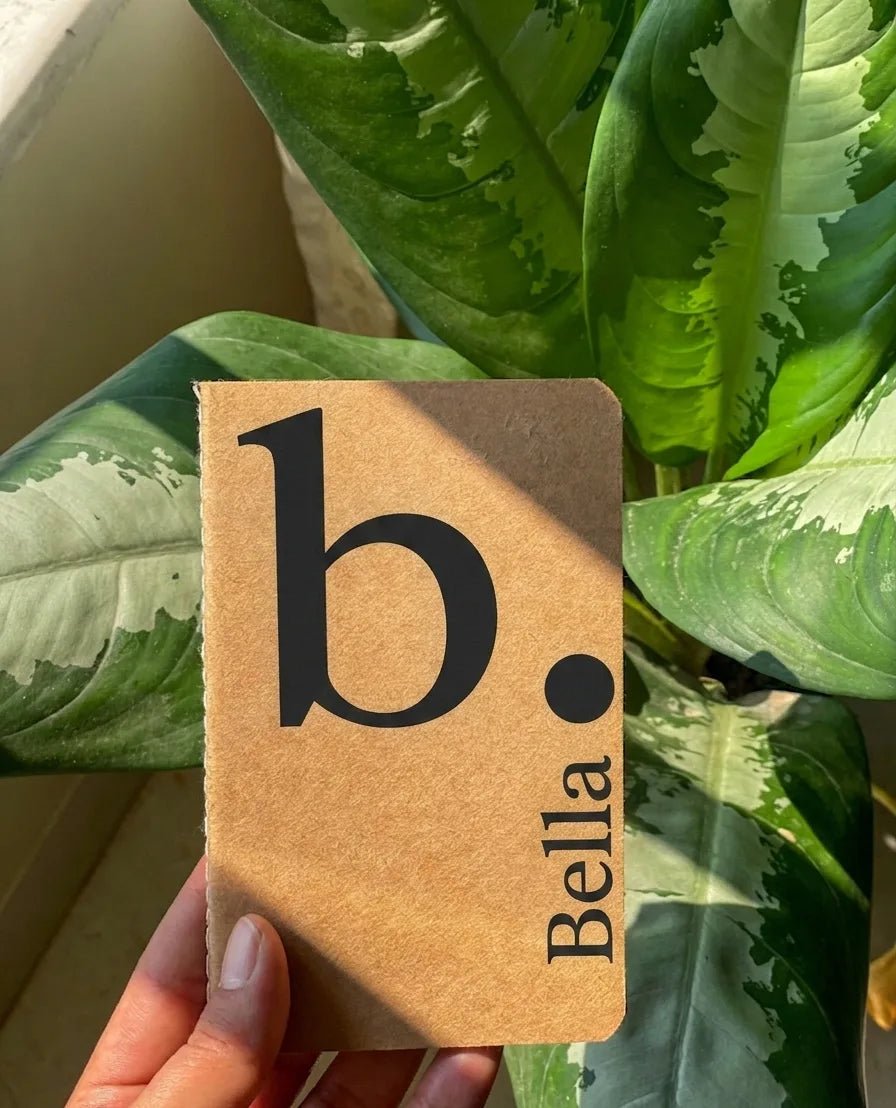 A pocket-sized stationery journal made of durable brown kraft paper, showcasing a clean custom initial layout on the front cover