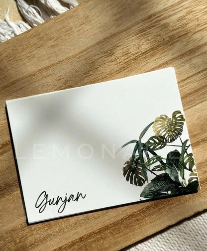 Close up of the vibrant green monstera leaf print and custom name typography