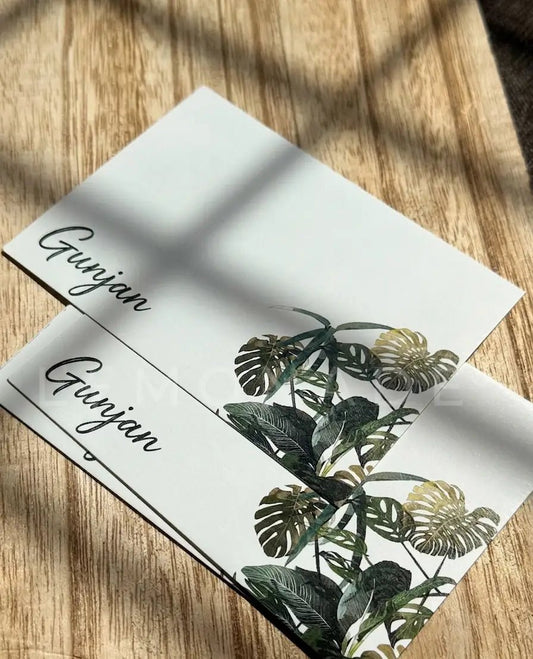 Flatlay of the monstera notecard set styled with natural botanical elements