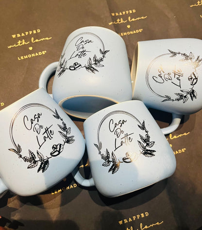 Top down view of custom initial mug with logo