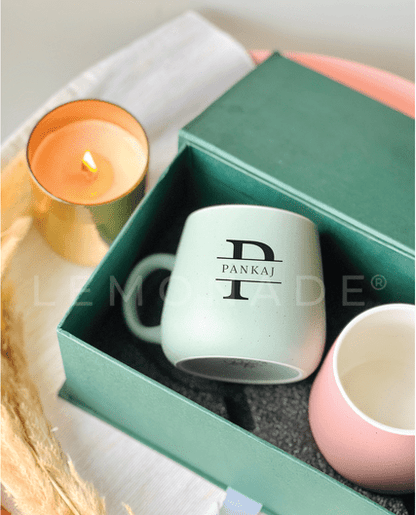 Close up of a premium monogram engraving on an assorted pastel mug