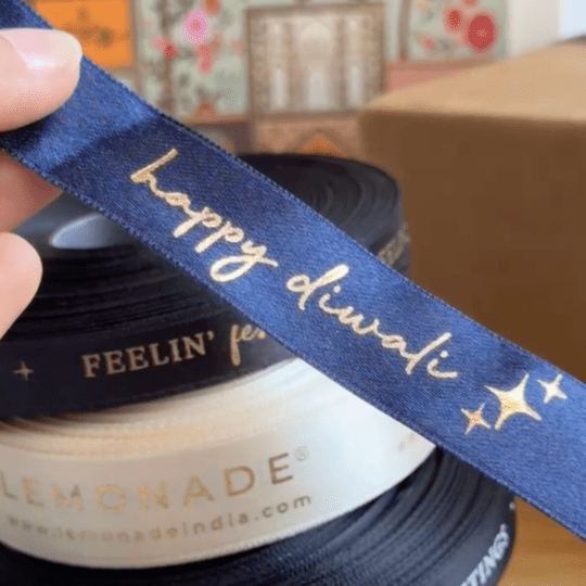 Pre-designed festive ribbon with printed designs for gift wrapping and decorations. Gold Foiled Satin Ribbon - LemonadeStationery